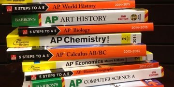 A stack of multi-colored AP test prep books