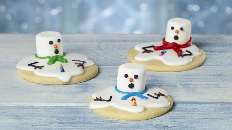 3 cookies with "melted" candy snowman toppings