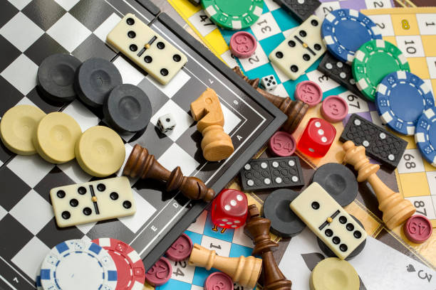 A bunch of different game pieces scattered over different game boards