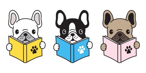 3 dogs holding books.