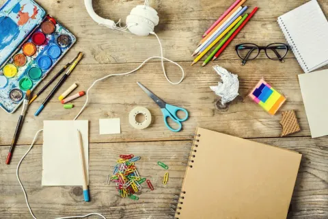 A table scattered with crafting supplies