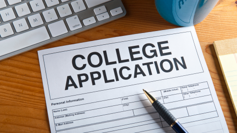 College application on a desk with a pen