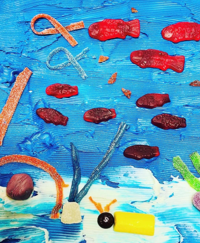 Picture has different pieces of candy that make up a underwater scene