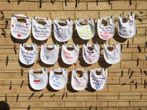 Self design baby bibs hanging on a clothesline