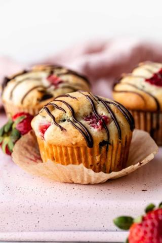 A picture of chocolate drizzled strawberry muffins