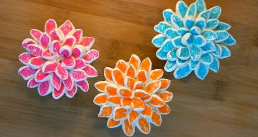 A top view of marshmallows cut and decorated to look like flowers.