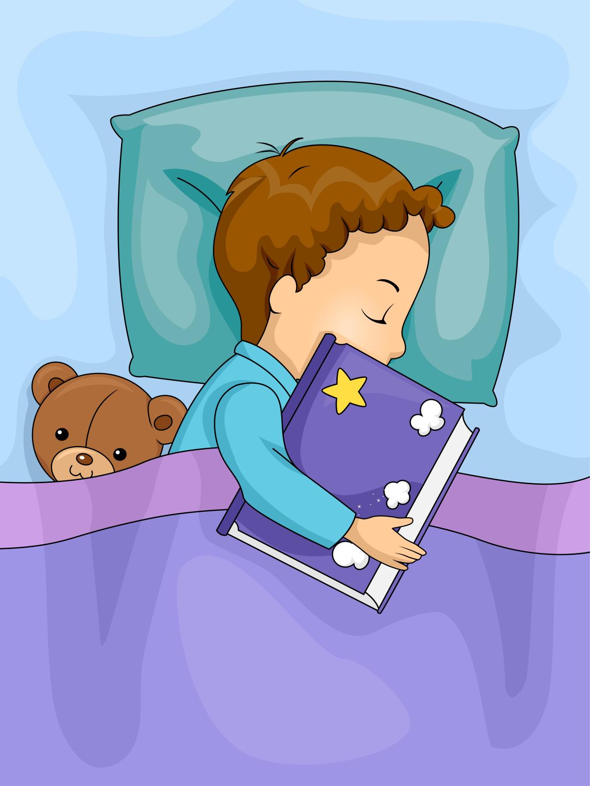 Boy holding book in bed.