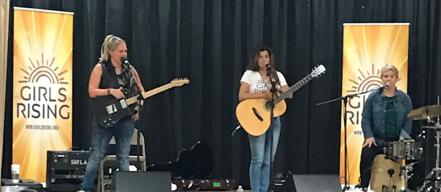 The band Antigone Rising, on stage with instruments.