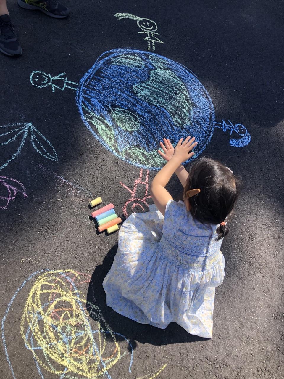 Child drawing with chalk