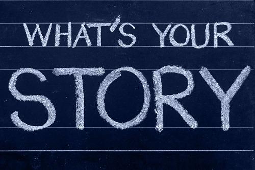 The words "What's Your Story" written in white chalk on a blue background