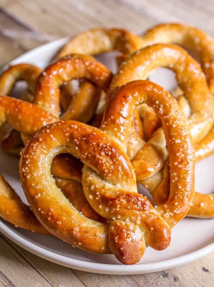 Soft pretzels on a white plate.