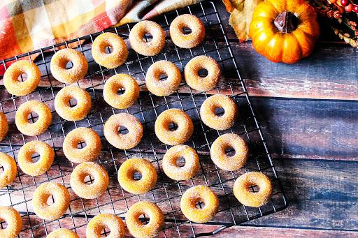 Mini donuts on a tray on the table with a Fall theme