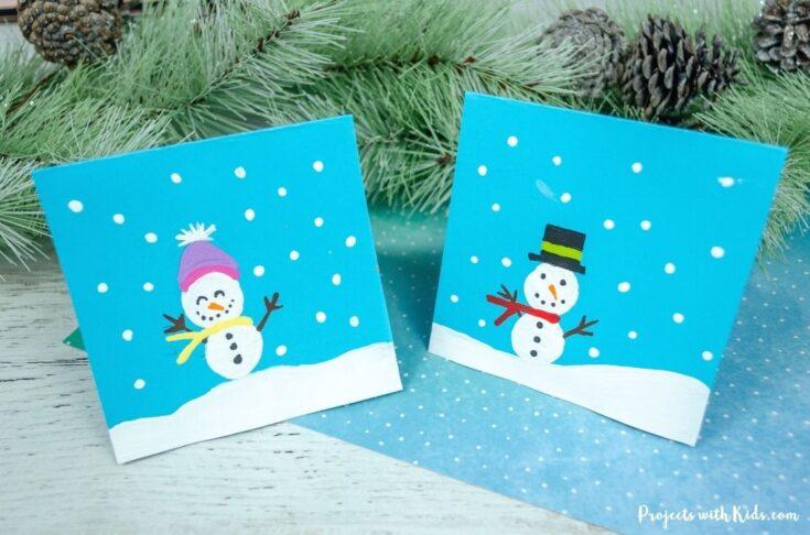 Two snowman winter cards on a table