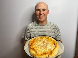 Chef Rob holding a pizza